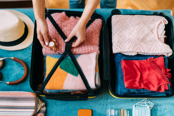 istock Woman packing suitcase for travel 1371909341