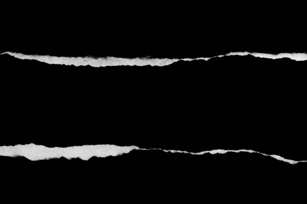 istock Ripped, torn paper edge isolated white on black, paper tear with space for copy 1371909562