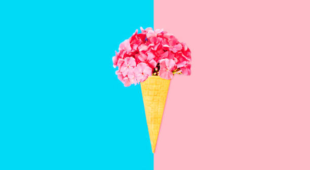 istock Cone ice cream with colorful flowers on blue background, blank copy space for advertising text 1371909854