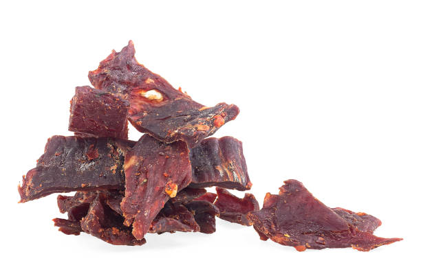 istock Portion of spiced beef jerky isolated on a white background. Beef jerky pieces. 1371911672