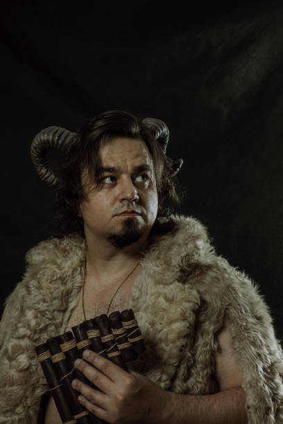 istock Horned faun with pan flute 1371911744