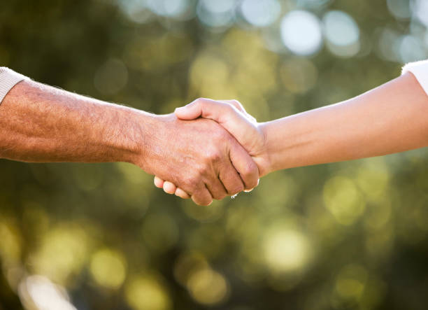 shot of two unrecognisable men shaking hands outdoors - agriculture teamwork farmer people imagens e fotografias de stock