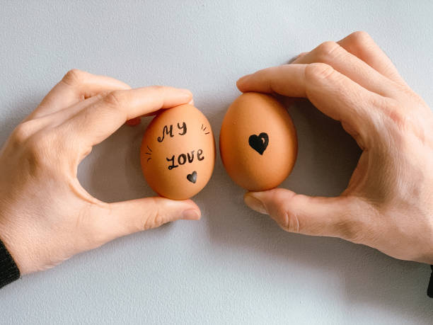 istock Happy Easter or st valentine’s morning before breakfast. Young couple holding eggs with declaration of love 1371911881
