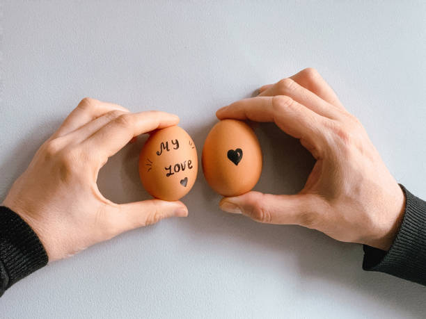 istock Happy Easter or st valentine’s morning before breakfast. Young couple holding eggs with declaration of love 1371911938