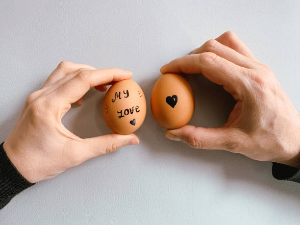 istock Happy Easter or st valentine’s morning before breakfast. Young couple holding eggs with declaration of love 1371912016