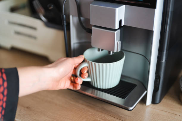 istock Woman use coffee machine to make coffee 1371912045