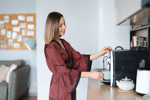 istock Woman use coffee machine to make coffee at home 1371912050