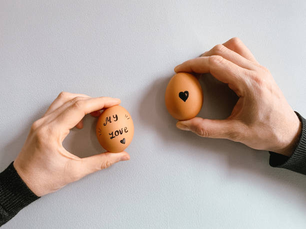 istock Happy Easter or st valentine’s morning before breakfast. Young couple holding eggs with declaration of love 1371912055