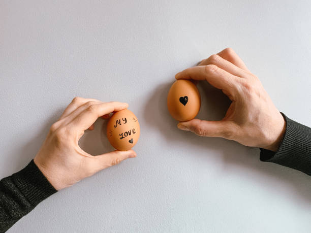 istock Happy Easter or st valentine’s morning before breakfast. Young couple holding eggs with declaration of love 1371912145