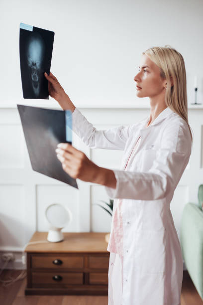 istock Female trauma surgeon examines skull scans in office 1371912196