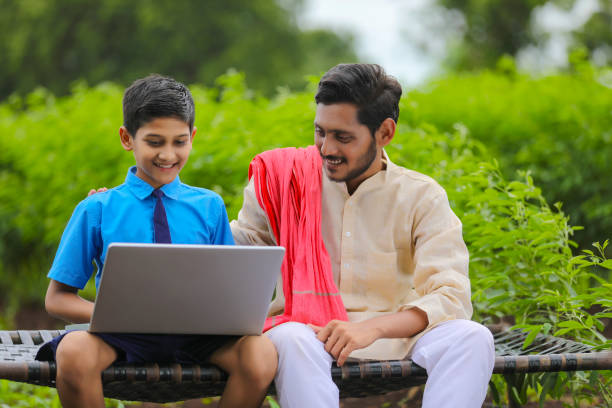 istock Education concept :cute indian school boy using laptop and giving some information to his father. 1371912976