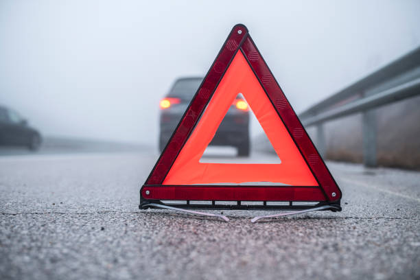 istock Warning triangle on the road for car breakdown. 1371913182