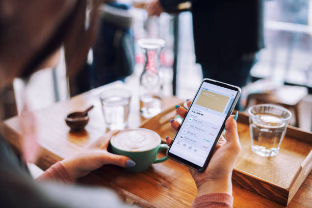 istock Managing online banking on cafe. 1371913203