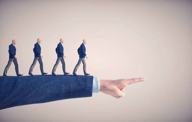 istock Group of men walks on a hand pointing forward. 1371914604