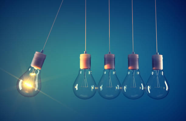 istock Newton's cradle made of light bulb. 1371914613
