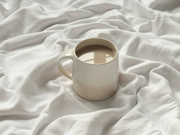 istock Cup of coffee on a white textile background 1371915172