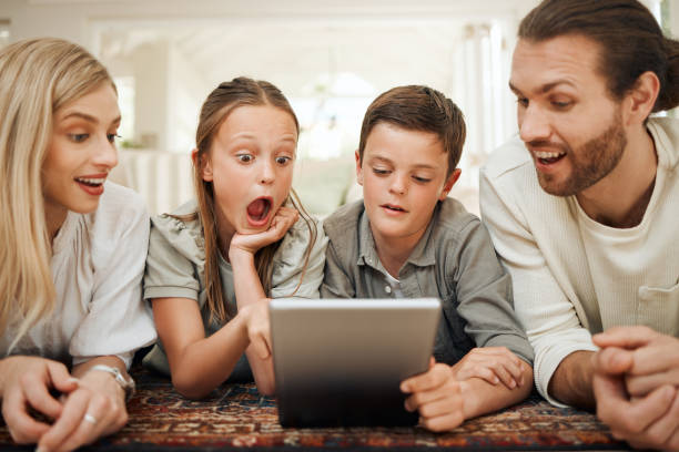 istock Shot of a young family spending time together at home while using a digital tablet 1371917757