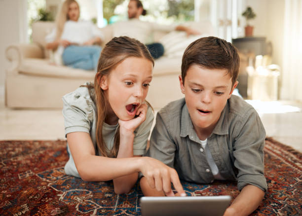 istock Shot of a young brother and sister playing together while using a digital tablet 1371917982