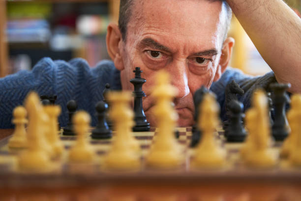 istock Business strategy concept. Senior executive thinking next chess move 1371917988