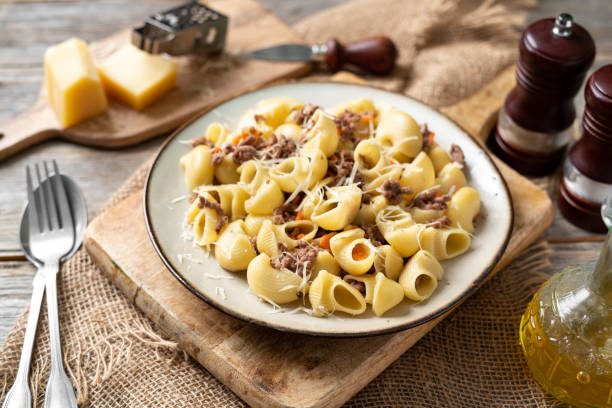 istock Pasta Pipe Rigate with stew In Bianco in a plate on a gray culinary background. Traditional Italian pasta with ground beef on the kitchen table closeup 1371918016