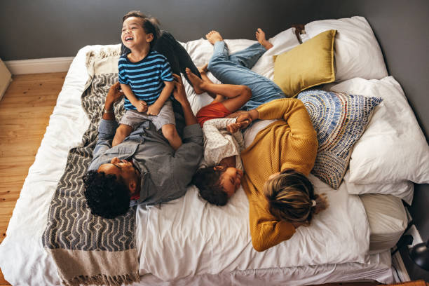 istock Parents playing with their children on the bed 1371919244