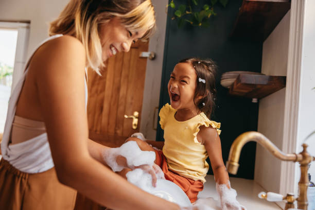 istock Mother and daughter laughing happily in the kitchen 1371919312