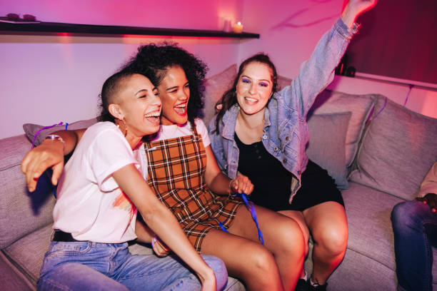 istock Group of girlfriends having fun at a house party 1371920363