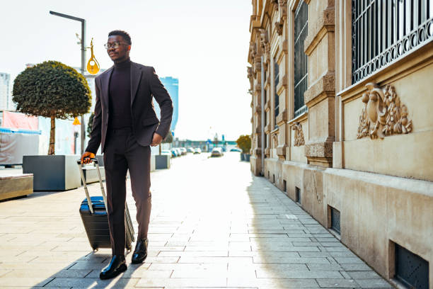 istock Businessman walking with luggage 1371920384