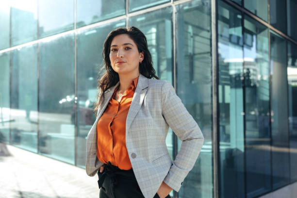 istock Female white collar worker looking at the camera outdoors 1371920430