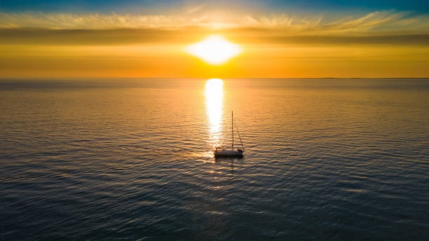 istock Sunset at sea with a yacht 1371920514