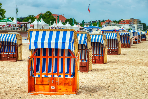 Travemunde, Germany - July 22, 2016: Covered chairs on the sandy beach Travemunde, Baltic Sea.