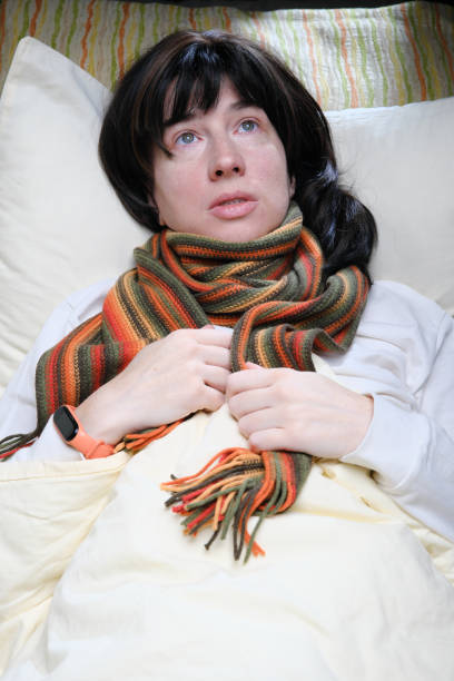 istock Woman having cold or flu symptoms is lying in bed 1371922010
