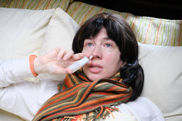 istock Woman having cold or flu symptoms is lying in bed 1371922351
