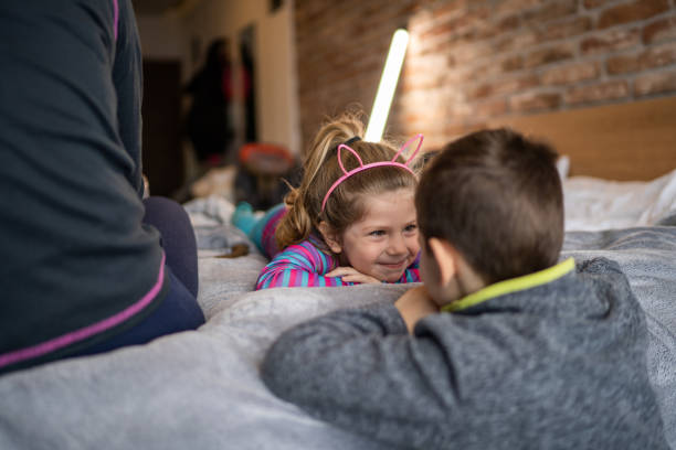 istock Cute brother and sister looking each other and smiling 1371922611
