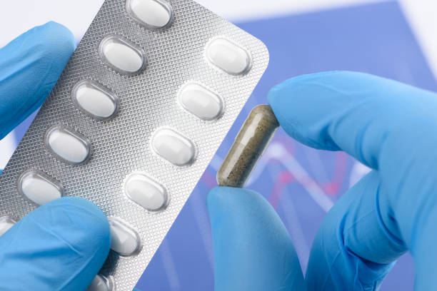 istock Scientist hold and compare transparent capsule and blister pack 1371922714
