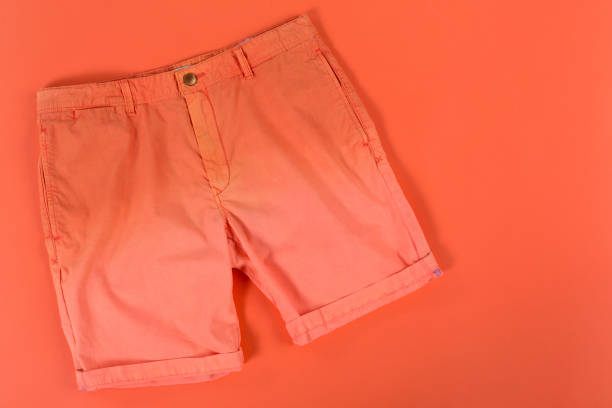 istock orange men's shorts, on an orange background, concept 1371923770