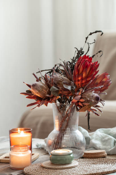 istock Cozy home composition with candles and protea bouquet. 1371925096
