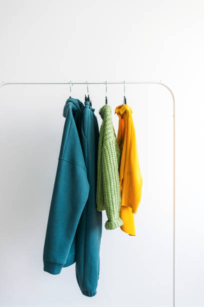 Bright colorful collection of clothes on a rack. Fashion concept stock photo