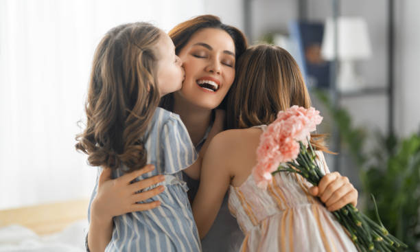 istock daughters are congratulating mother 1371926378