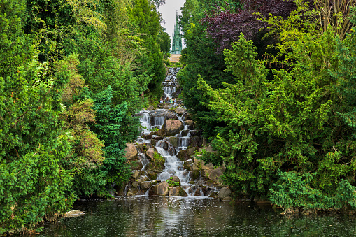 Waterfall in Viktoriapark in city of Berlin, Germany. Urban landscape park with manmade mountain in locality of Kreuzberg.