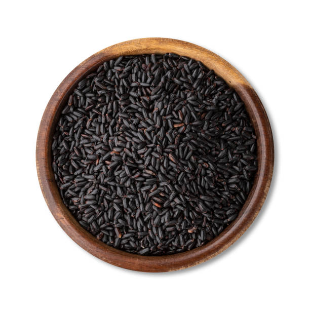 istock Raw black rice in a bowl isolated over white background 1371928060