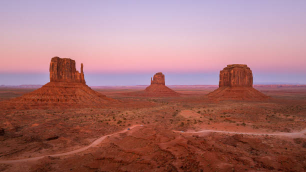 Beautiful sunset over the red rocks of Monument Valley in Arizona Monument Valley is a region of the Colorado Plateau characterized by a cluster of vast sandstone buttes. It is located on the Utah-Arizona state line, near the Four Corners area. The valley is a sacred area that lies within the territory of the Navajo Nation Reservation, the Native American people of the area, and is accessible from U.S. Highway 163. moonland stock pictures, royalty-free photos & images