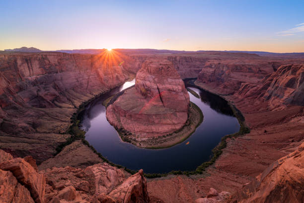 Sunset at Horseshoe Bend Overlook at Page in Arizona Horseshoe Bend is a horseshoe-shaped incised meander of the Colorado River located near the town of Page, Arizona in the United States. It is also referred to as the "east rim of the Grand Canyon". horseshoe bend river stock pictures, royalty-free photos & images
