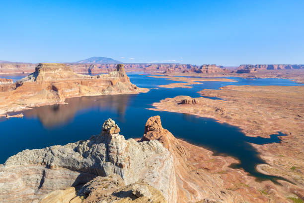 View from Alstrom Point over Lake Powell and the Gunsight Bay in Utah Alstrom Point is a landmark located in Glen Canyon National Recreation Area, in Kane County of southern Utah. This iconic landmark of the Lake Powell area is a cape that extends south into Lake Powell between Padre Bay and Warm Creek Bay. Alstrom Point rises nearly 1,000 feet above the lake when it's full. gunsight butte stock pictures, royalty-free photos & images