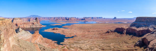 View from Alstrom Point over Lake Powell and the Gunsight Bay in Utah Alstrom Point is a landmark located in Glen Canyon National Recreation Area, in Kane County of southern Utah. This iconic landmark of the Lake Powell area is a cape that extends south into Lake Powell between Padre Bay and Warm Creek Bay. Alstrom Point rises nearly 1,000 feet above the lake when it's full. gunsight butte stock pictures, royalty-free photos & images