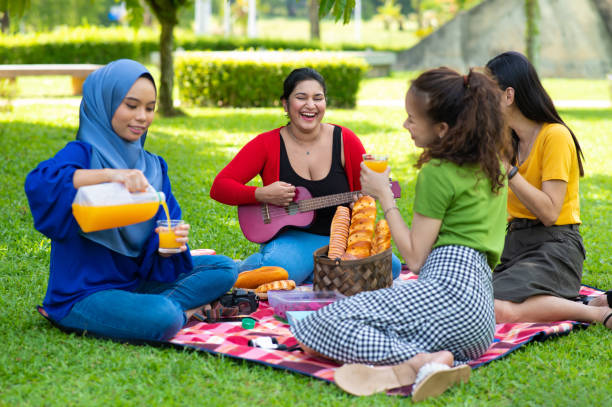 istock Friends enjoying picnic outing. 1371928585