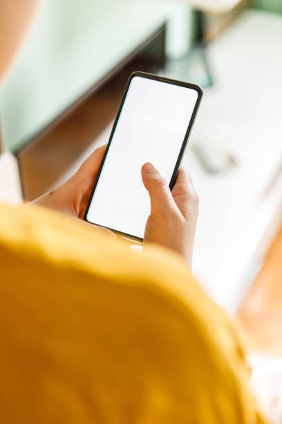 istock Smart mobile phone with blank screen in woman's hands, cut out shot 1371931694