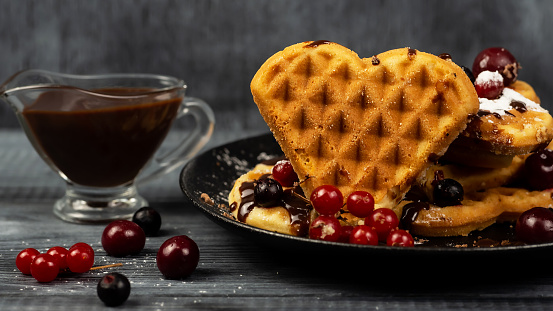 Croissant Waffle or Croffle with chocolate sauce and berries.