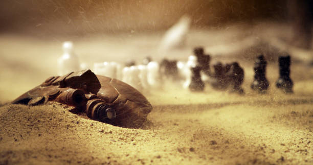 Chess gameplay on desert. Postapocalyptic mood, abandoned camp