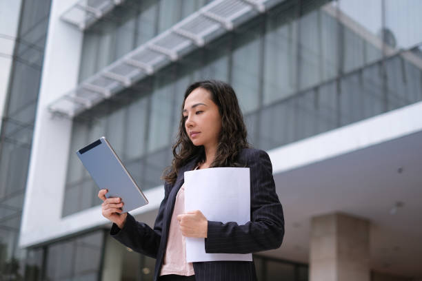 Asian Business Woman Checking Data From Digital Tablet stock photo